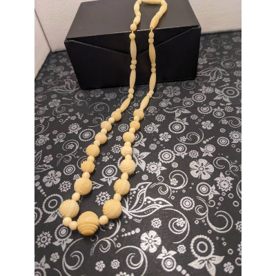 Schöne elfenbeinfarbige, halsnahe Kette.