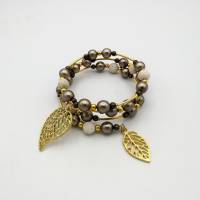 Spiralförmiger Perlen - Armreifen in creme, gold, taupe, ca. 6,5cm Durchmesser, passt sich an. Bild 1