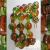 Spiralarmreif mit Glasperlen Farbenspiel in Orange und Grün Bild 2