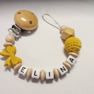 Schnullerkette mit Namen in Senfgelb/Holz mit Häkelperle und Schleife