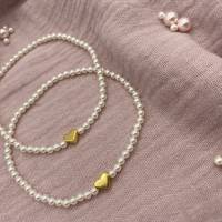 Perlenarmband mit weißen Perlen und kleinem Herz. Bild 7